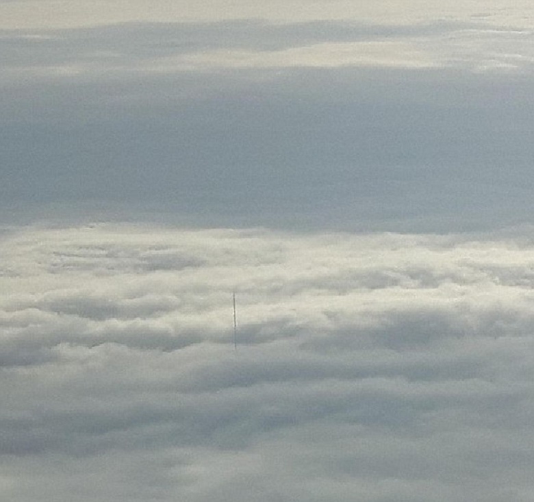 Пассажиры самолета увидели огромный шпиль, выглядывающий из облака