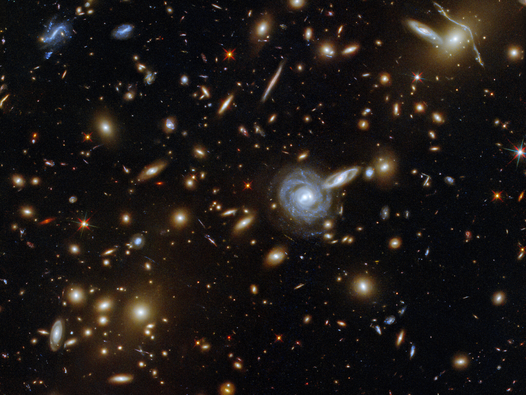 На снимке Мэя изображено массивное скопление галактик под названием ACO S 295, и вы можете увидеть бесчисленное количество галактик всех форм и размеров. Предоставлено: ЕКА / Хаббл и НАСА, Ф. Пакод, Д. Коу.